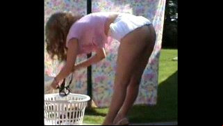 Milf hanging the washing no bra or panties in view of the roadside.