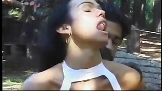 A lucky guy gets to fill the mouth and ass of this beautiful tanned shemale in the forest meadow.